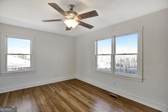 empty room featuring ceiling fan and hardwood / wood-style floors