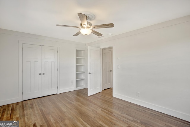 unfurnished bedroom with light hardwood / wood-style flooring, a closet, and ceiling fan