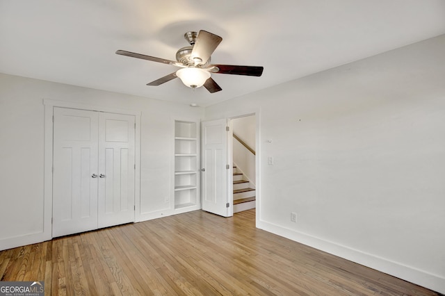 unfurnished bedroom with a closet, ceiling fan, and light wood-type flooring