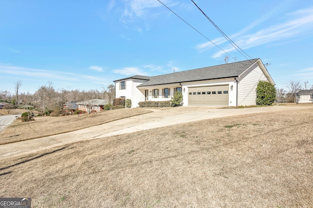 view of front of home with a garage and a front lawn