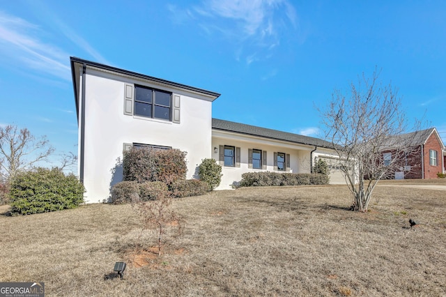 view of front facade with a garage and a front yard