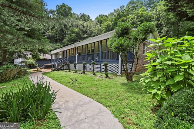 exterior space featuring a lawn and a porch