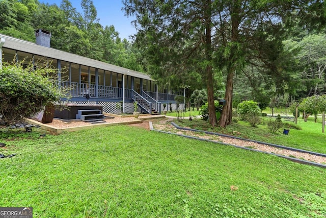 view of yard featuring a sunroom