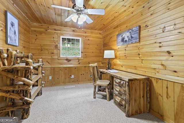 office with wood ceiling, ceiling fan, carpet floors, and wood walls