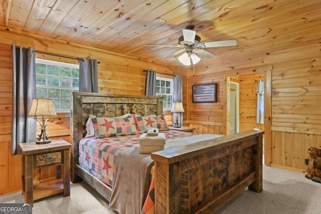 bedroom featuring wood ceiling, light colored carpet, multiple windows, and wood walls