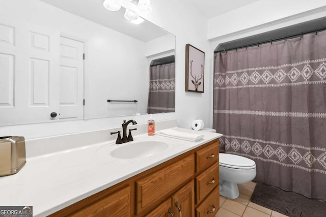 bathroom with vanity, toilet, curtained shower, and tile patterned flooring