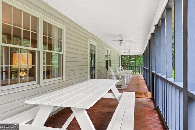 deck with ceiling fan and covered porch