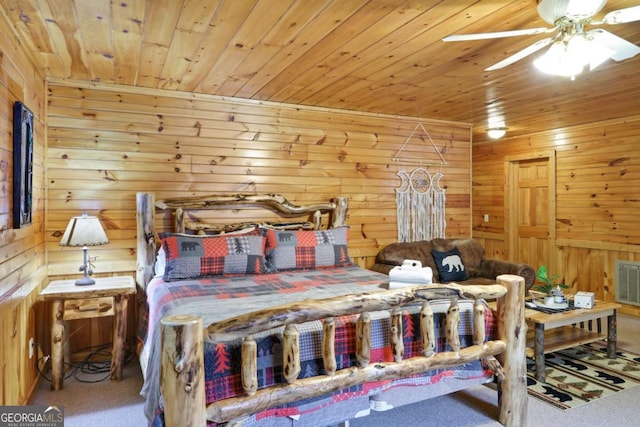 carpeted bedroom with wood ceiling and wood walls