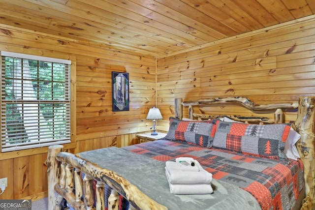 bedroom with multiple windows, wooden ceiling, and wooden walls