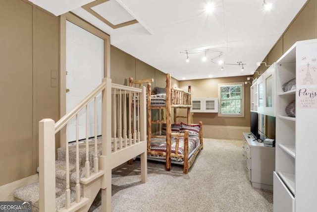 carpeted bedroom with track lighting