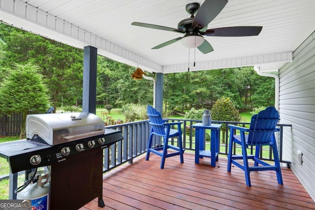 wooden deck featuring a grill and ceiling fan