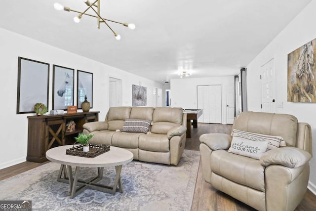 living room with an inviting chandelier and wood-type flooring