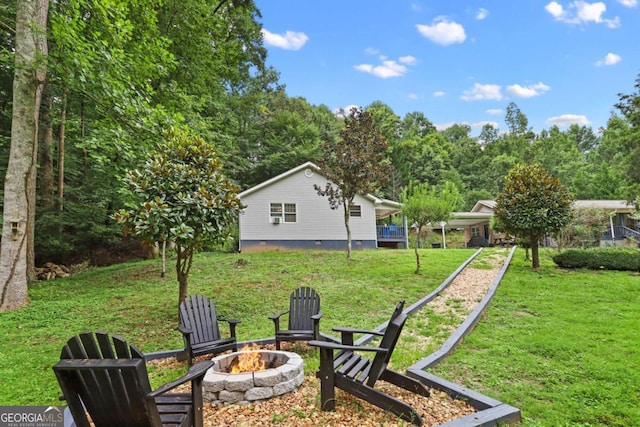 view of yard with an outdoor fire pit