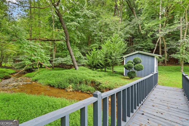 deck featuring a shed and a water view