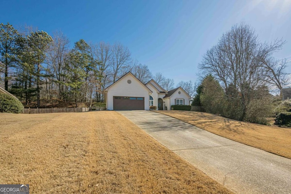 view of front of home featuring a garage and a front yard