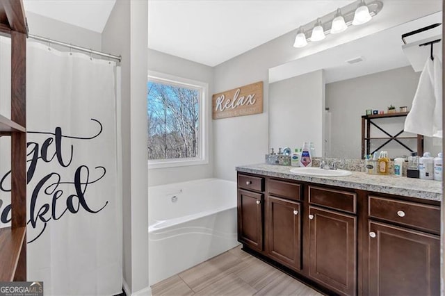 bathroom with vanity and a bathtub