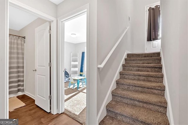 stairs featuring wood-type flooring