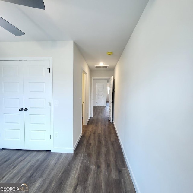 hallway with dark hardwood / wood-style flooring