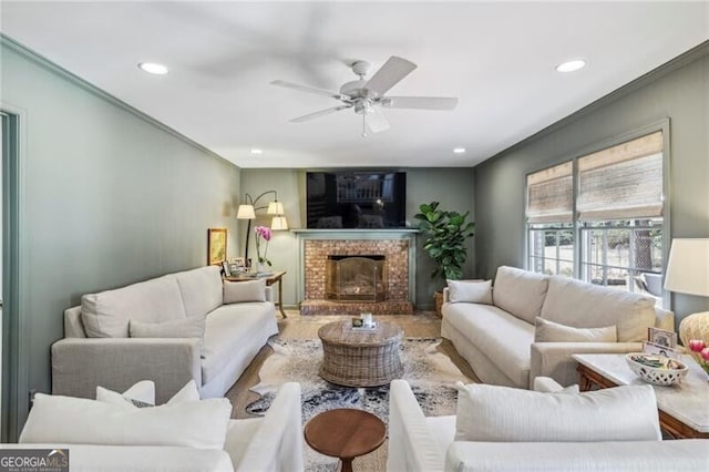 living room with ceiling fan, hardwood / wood-style floors, and a fireplace