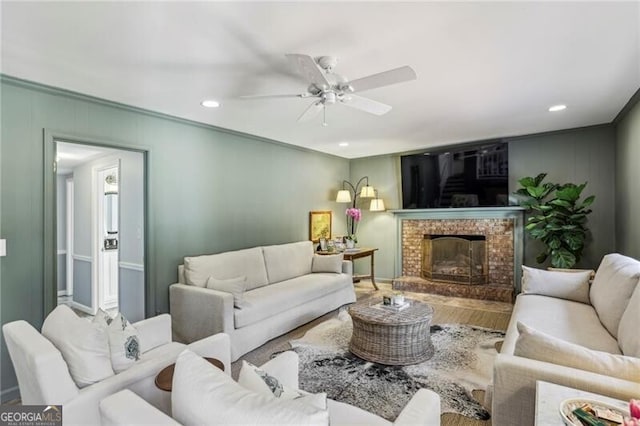 living room with hardwood / wood-style flooring, a fireplace, and ceiling fan