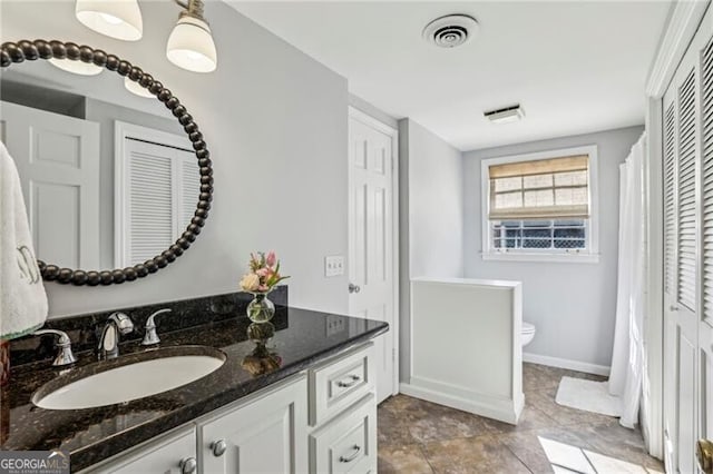 bathroom with vanity and toilet