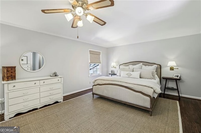 bedroom with dark hardwood / wood-style flooring and ceiling fan