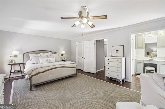 bedroom featuring dark wood-type flooring, ceiling fan, and connected bathroom