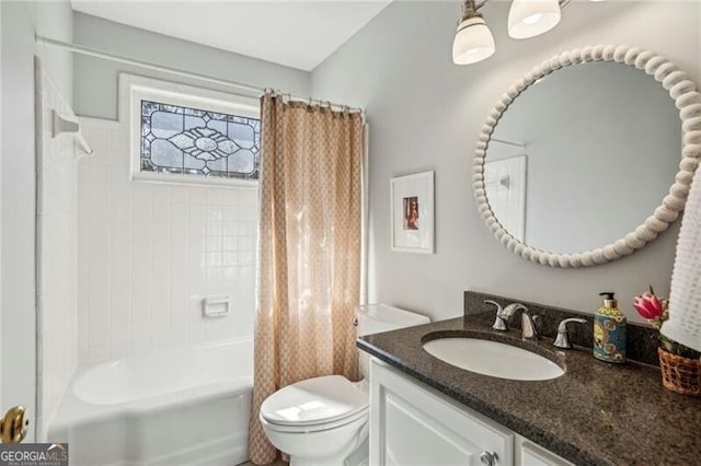 full bathroom featuring vanity, shower / tub combo, and toilet