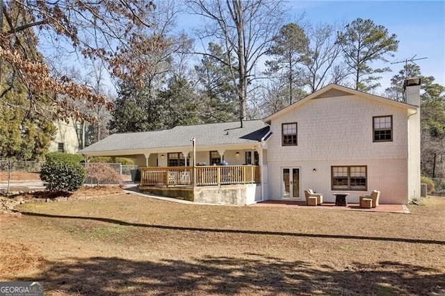 rear view of house featuring a yard