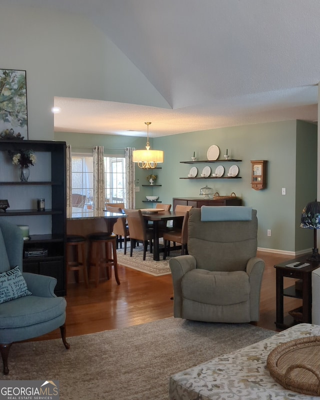 living room with hardwood / wood-style flooring and high vaulted ceiling