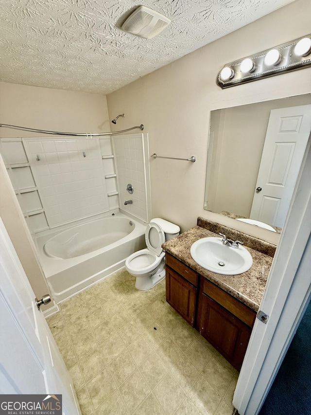 full bathroom with vanity, toilet, bathing tub / shower combination, and a textured ceiling