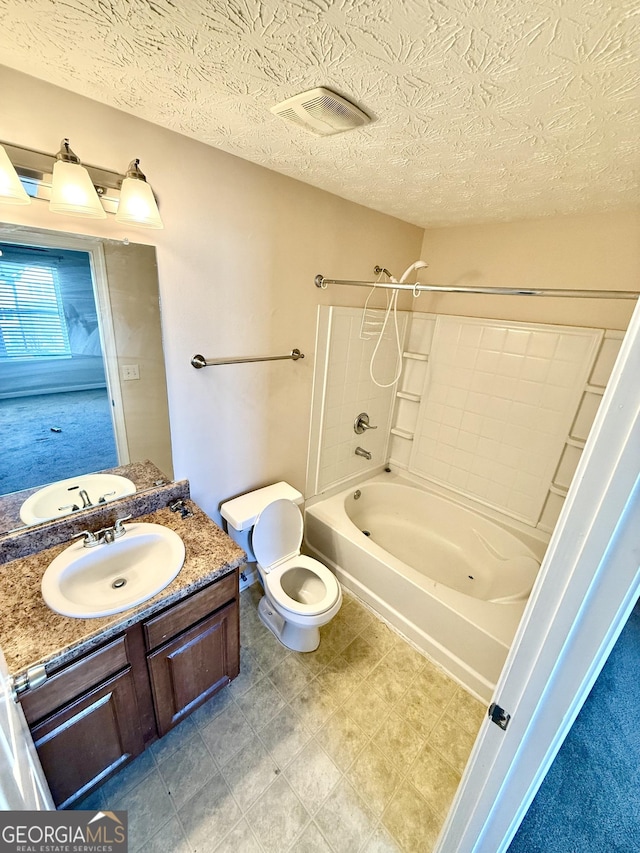 full bathroom featuring vanity, toilet, tub / shower combination, and a textured ceiling