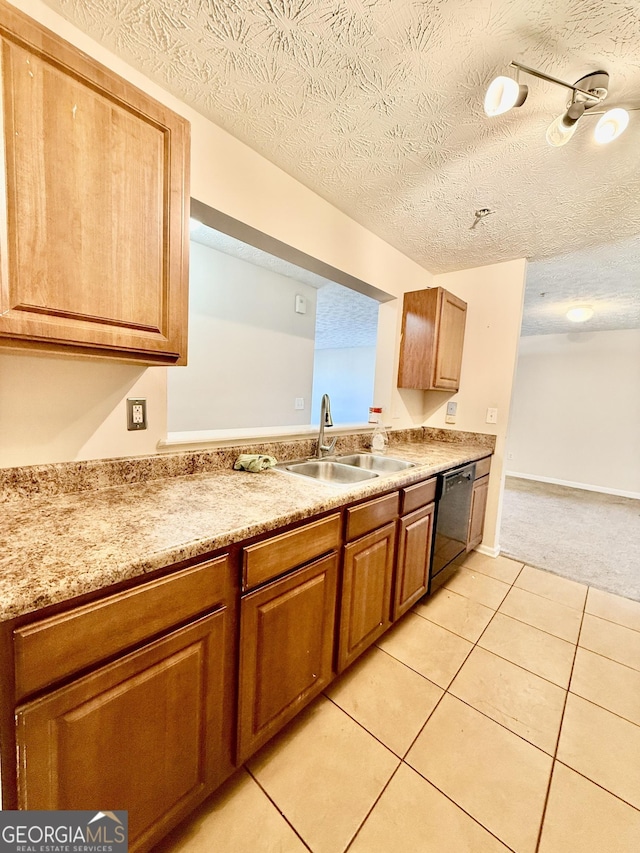 kitchen featuring dishwasher, sink, light carpet, and a textured ceiling