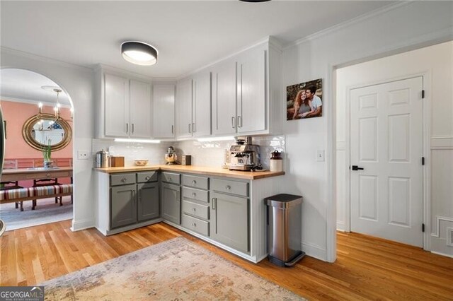 kitchen with appliances with stainless steel finishes, sink, white cabinets, and wood counters