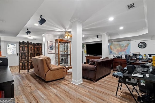 living room featuring hardwood / wood-style flooring, ceiling fan, and ornamental molding