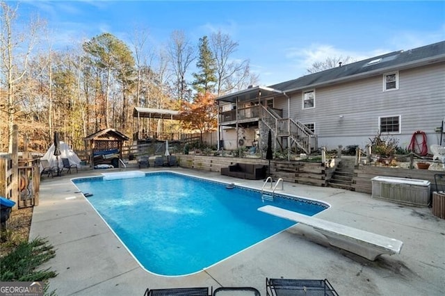 view of pool featuring a wooden deck and a jacuzzi