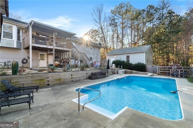 rear view of property with an outbuilding and a deck