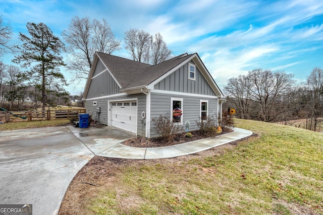 view of home's exterior featuring a garage and a yard