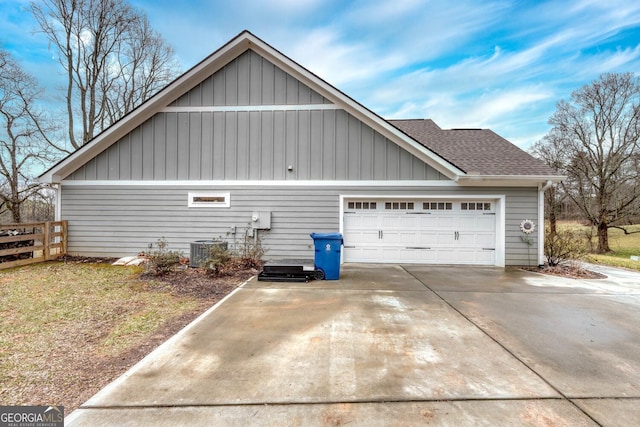 view of side of property featuring cooling unit and a garage