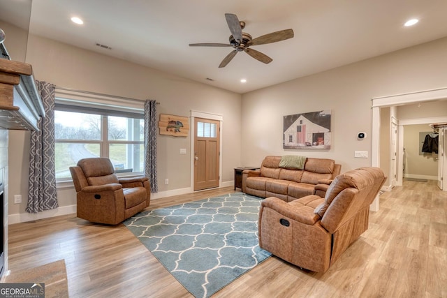 living room featuring ceiling fan and light wood-type flooring