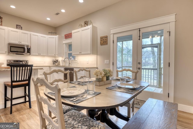 dining area featuring light hardwood / wood-style floors and french doors