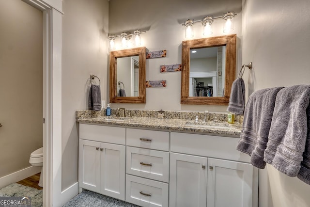 bathroom featuring vanity and toilet