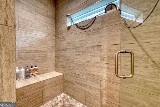 bathroom with tiled shower