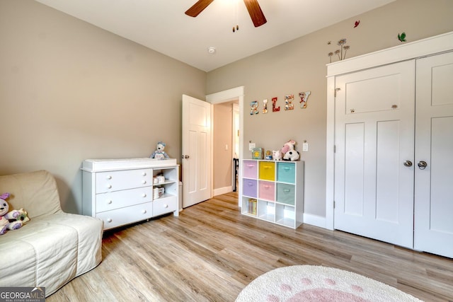 sitting room featuring light hardwood / wood-style flooring and ceiling fan