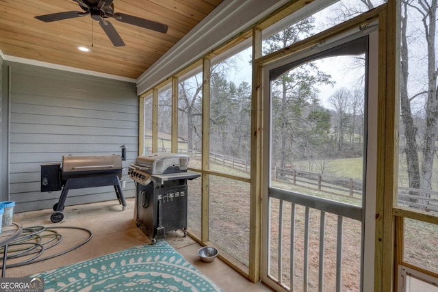 sunroom / solarium featuring wood ceiling and ceiling fan