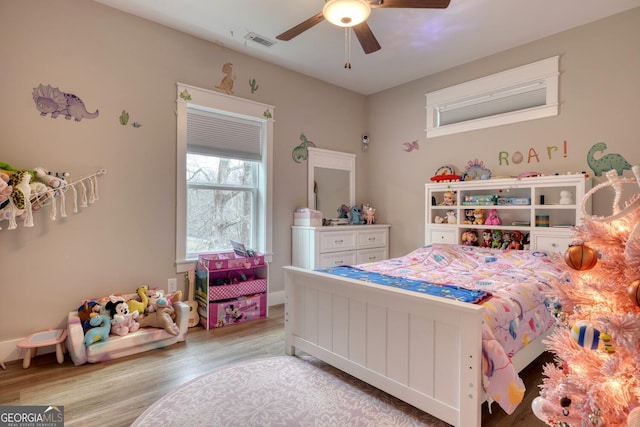 bedroom with light hardwood / wood-style flooring and ceiling fan