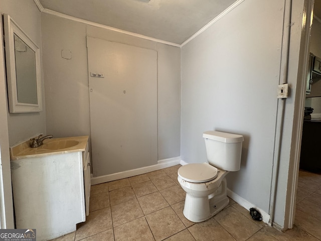 bathroom with crown molding, vanity, toilet, and tile patterned flooring