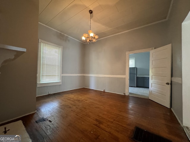 interior space with crown molding, dark wood-type flooring, and a notable chandelier