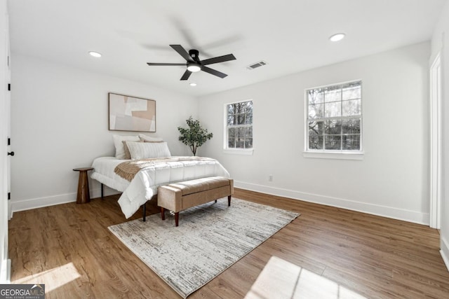 bedroom with hardwood / wood-style flooring and ceiling fan