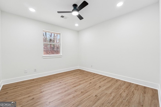 spare room featuring light hardwood / wood-style floors and ceiling fan